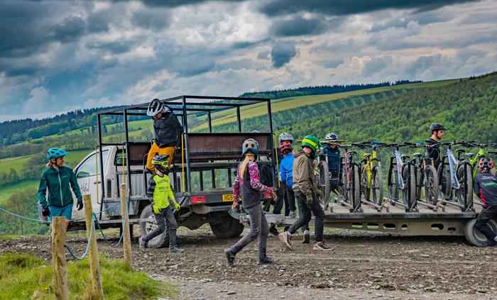 Riders of all ages disembarking the uplift vehicle